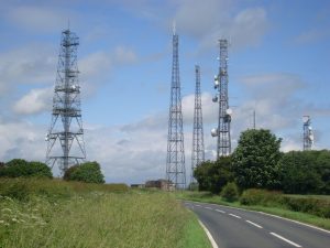Microwave and cellular towers like these increasingly fill the landscape.